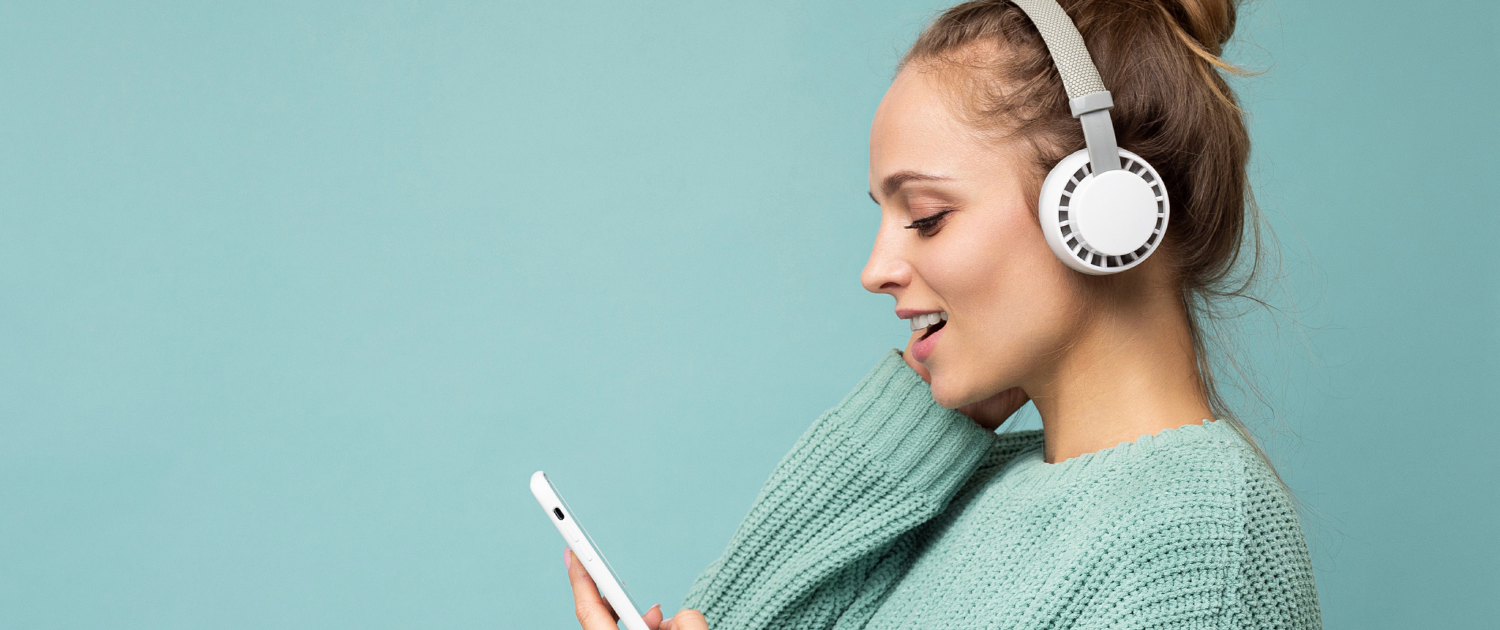 Header | Woman listening with headphones teal