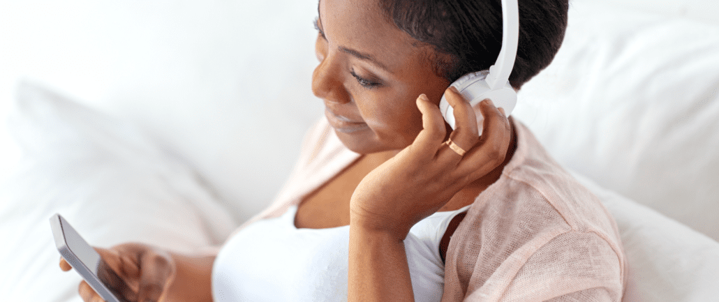 Header | Woman Listening on Headphones
